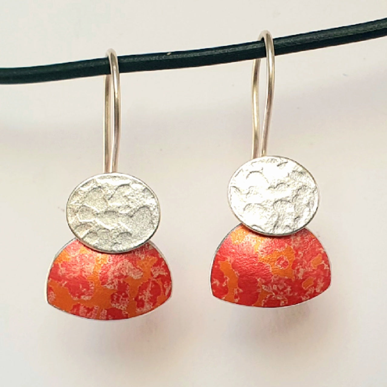 LCH2 Little silver oval drop earrings with patterned anodised aluminium skirt