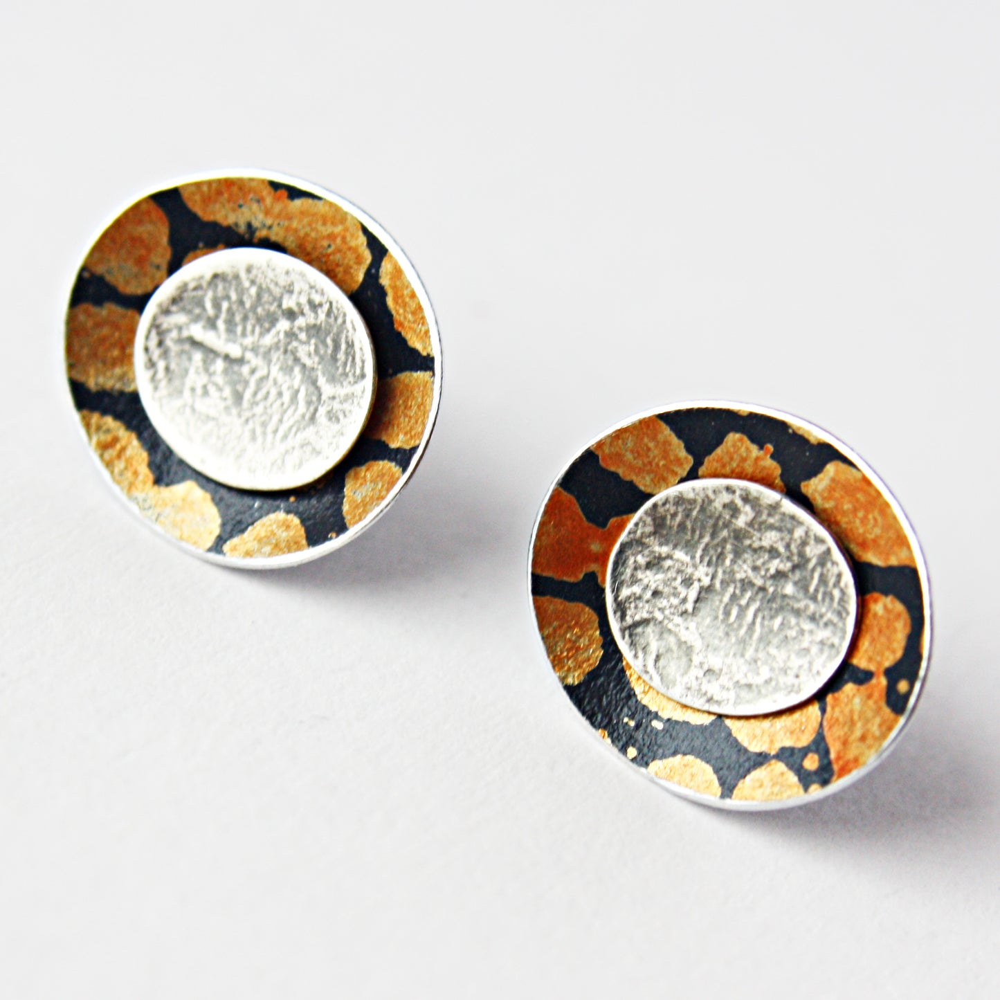 SL39 Orange spotty concave oval stud earrings with textured silver centre