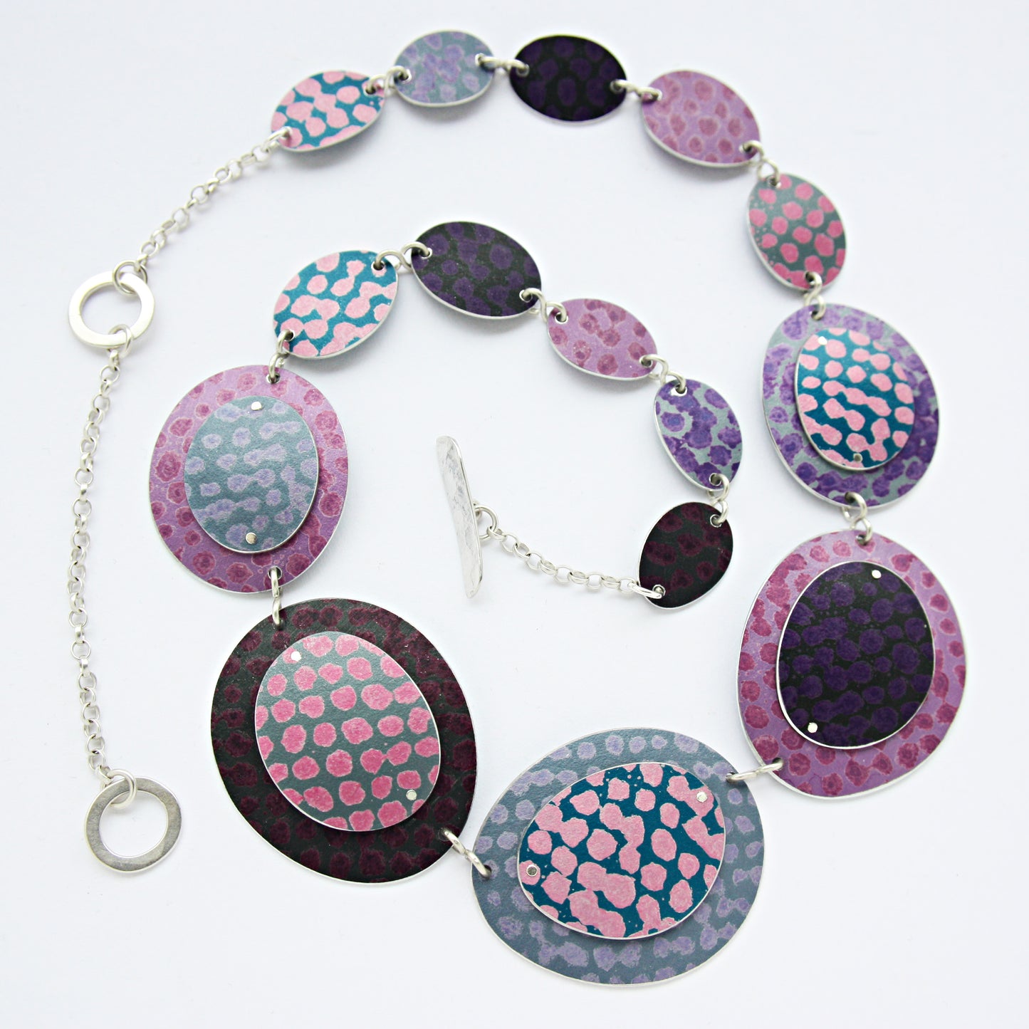 SL53 Hotchpotch spotty riveted ovals necklace in mauve, pink, and berry
