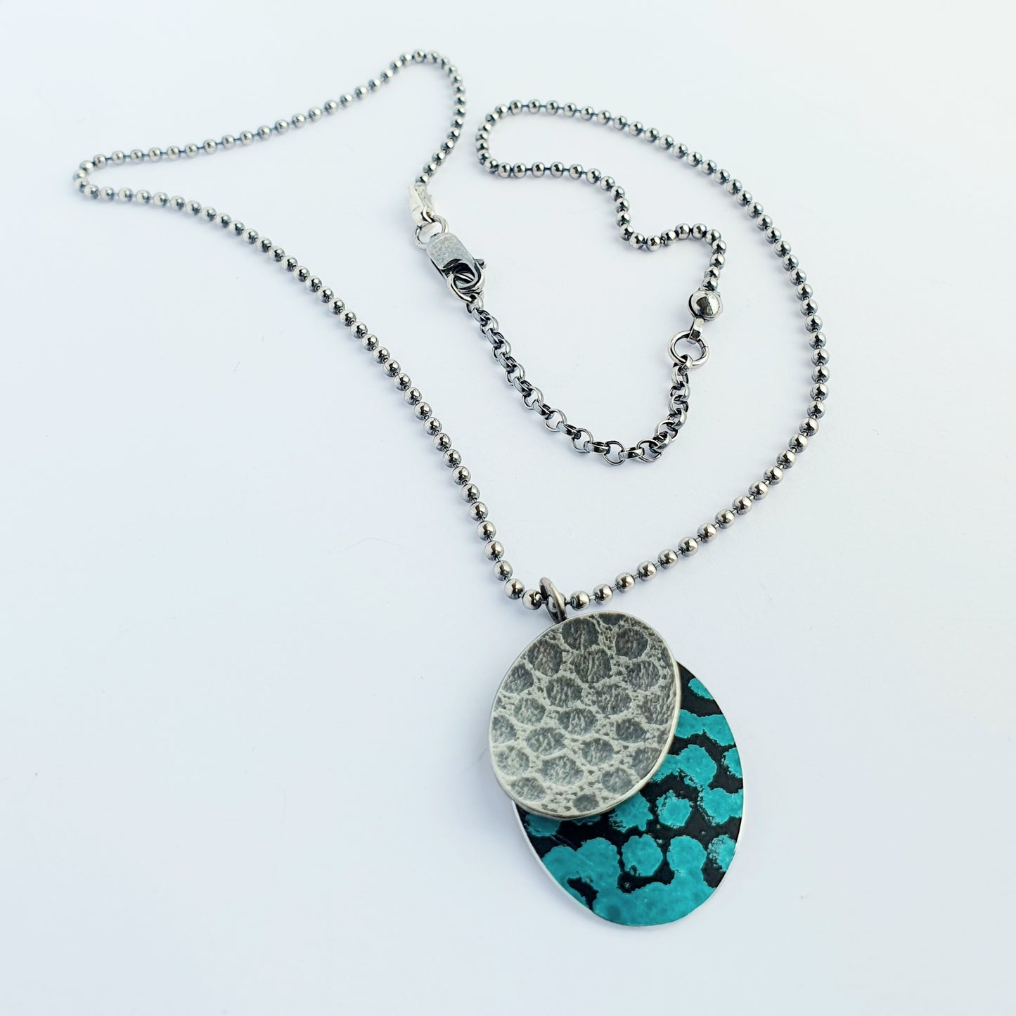SL20 Oxidised textured silver and turquoise blue spotty ovals pendant